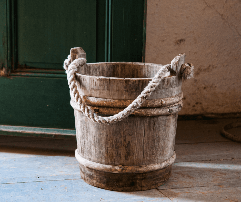 An old wooden bucket with a rope handle